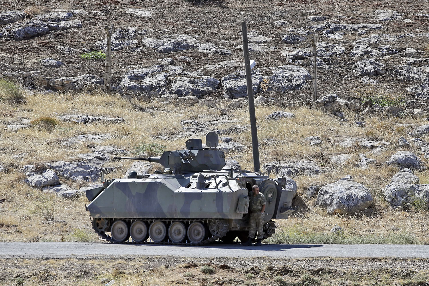 A Turkish soldier stands by a tank as he patrols the border with Syria, near Cilvegozu, Turkey, opn Wednesday.