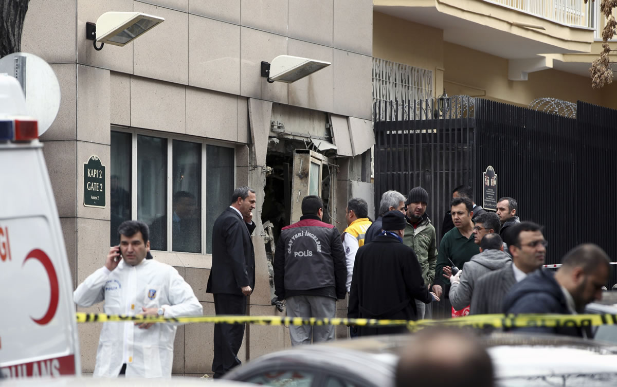 Emergency personnel are seen in front of a side entrance of the U.S. Embassy in the Turkish capital, Ankara, after a suspected suicide bomber detonated an explosive device, Friday, Feb. 1. The bomb appeared to have exploded inside the security checkpoint at the entrance of the visa section of the embassy.