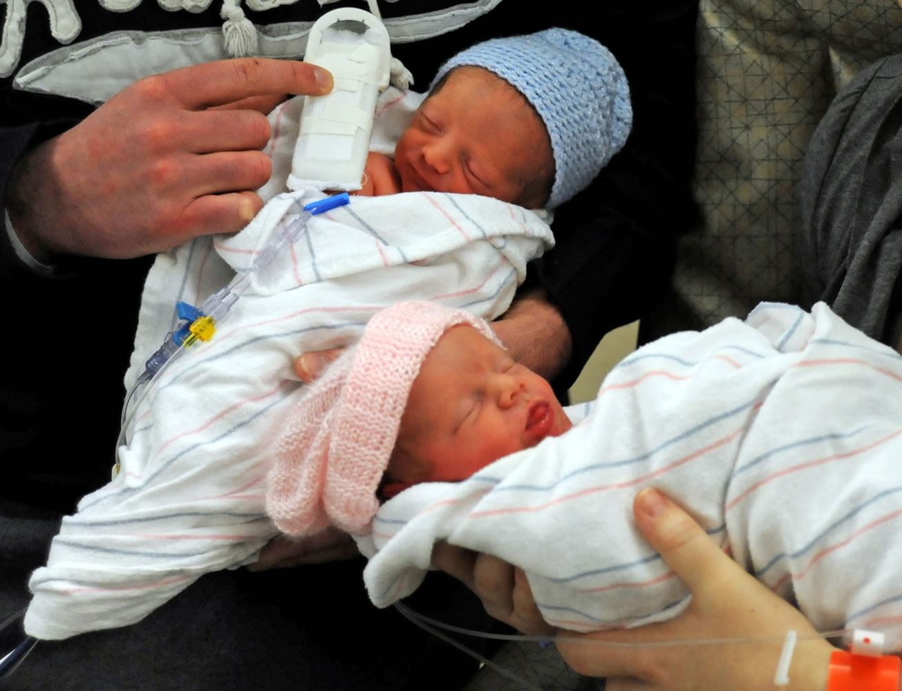Parents hold their twin newborns at the Hennepin County Medical Center in Minneapolis.