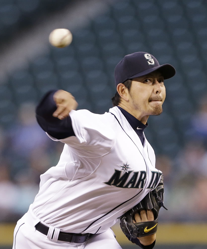 Mariners starting pitcher Hisashi Iwakuma throws against the Minnesota Twins in the fifth inning.