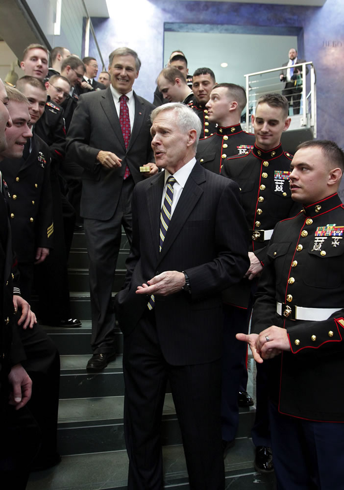Secretary of the Navy Ray Mabus, center front, greets Navy personnel after hosting a ship-naming ceremony Thursday in honor of the future USS Washington at the Port of Seattle headquarters. Washington Gov.