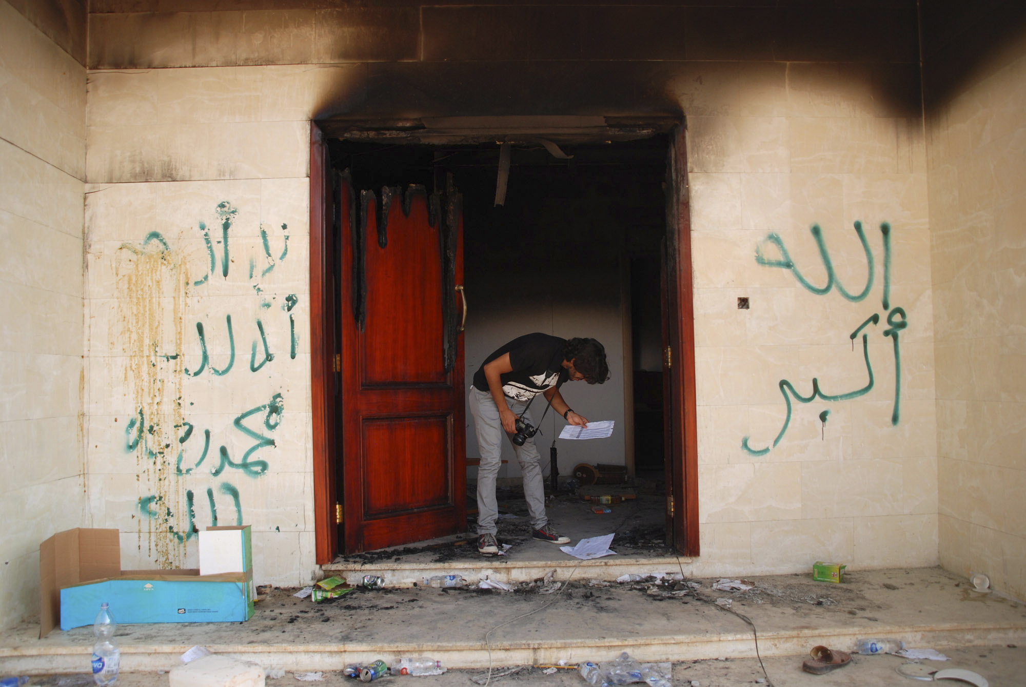 A man looks at documents at the U.S. consulate in Benghazi, Libya, Sept.