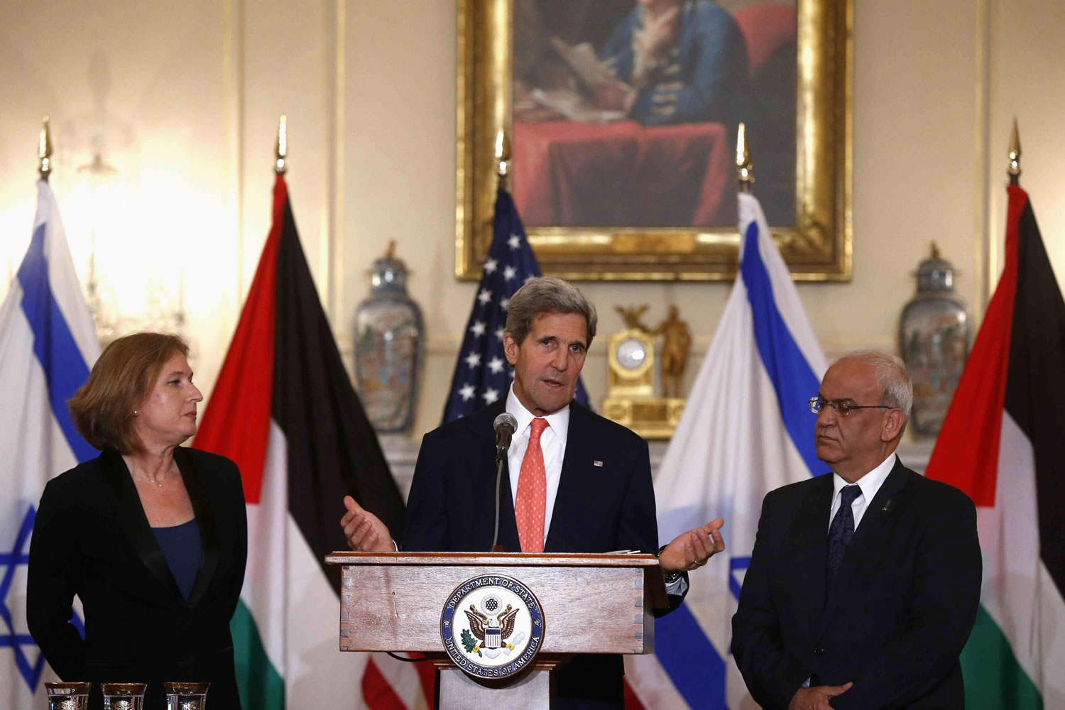 Secretary of State John Kerry stands with Israel's Justice Minister and chief negotiator Tzipi Livni, left, and Palestinian chief negotiator Saeb Erekat after the resumption of Israeli-Palestinian peace talks Tuesday at the State Department in Washington.