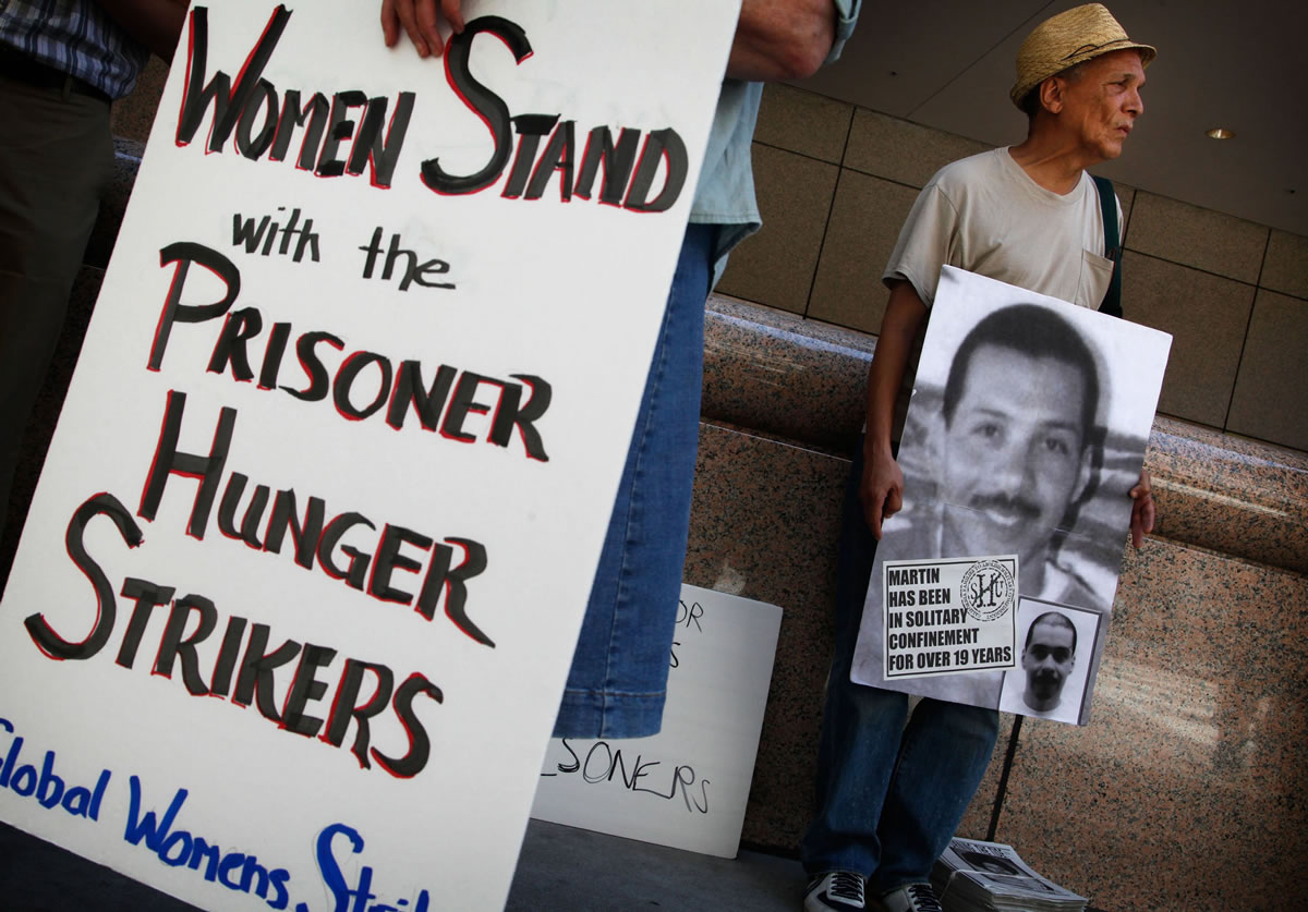 John A. Imani, right, joins demonstrators Monday, July 8, 2013, in Los Angeles, California, for a rally in support of Pelican Bay State Prison inmates that are on a hunger strike in protest of state prisons' conditions.