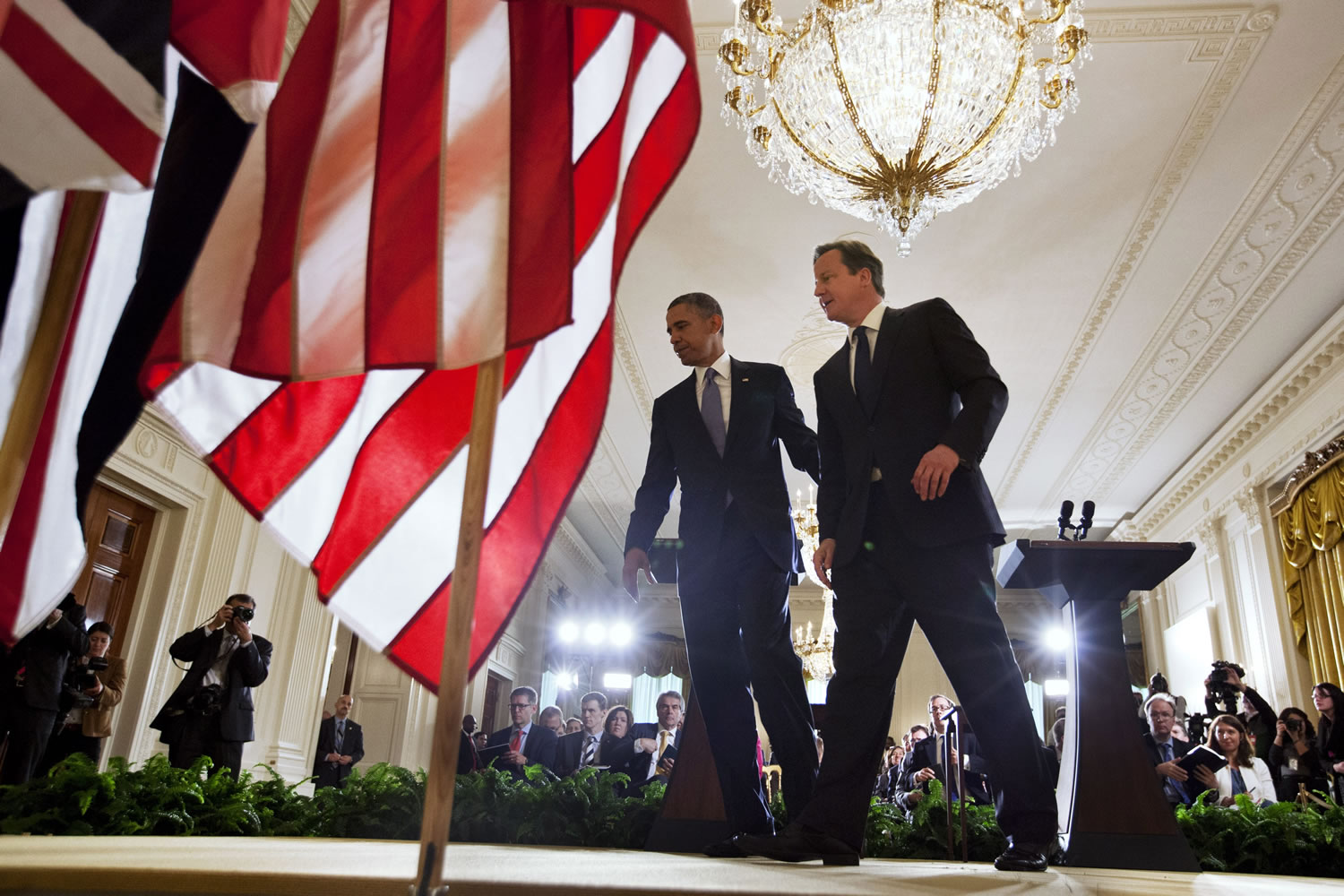 President Barack Obama and British Prime Minister David Cameron walk off the stage after their joint news conference Monday in the East Room of the White House in Washington, where they talked about various topics including Syria's civil war.