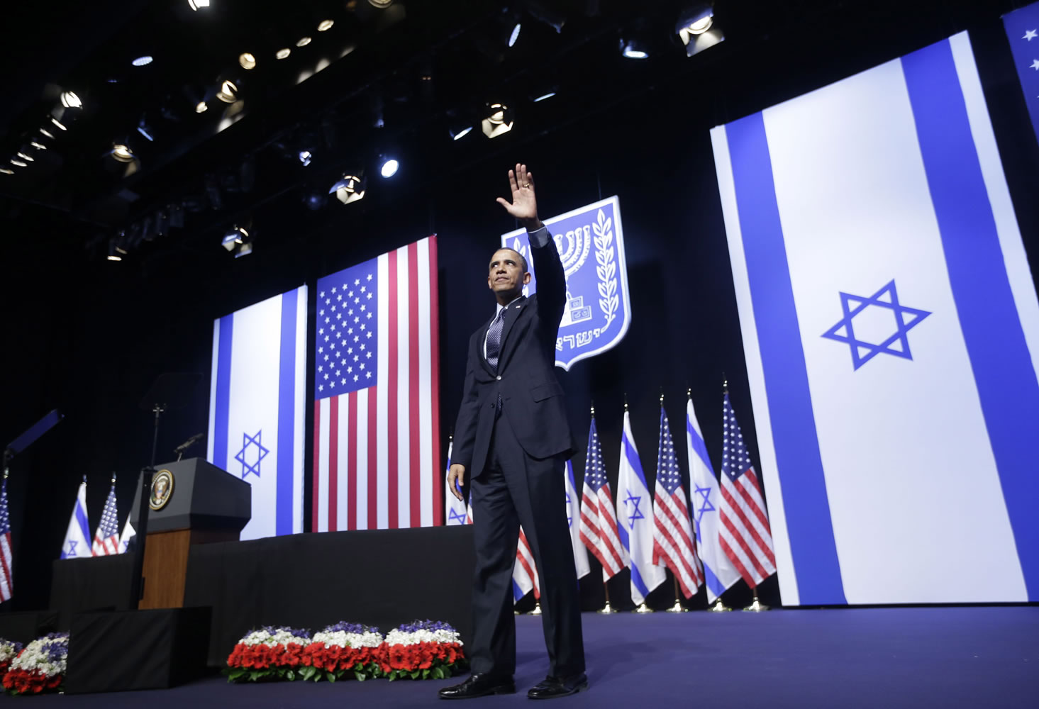 President Barack Obama waves to the crowd after speaking at the Jerusalem Convention Center in Jerusalem, Israel, on Thursday.