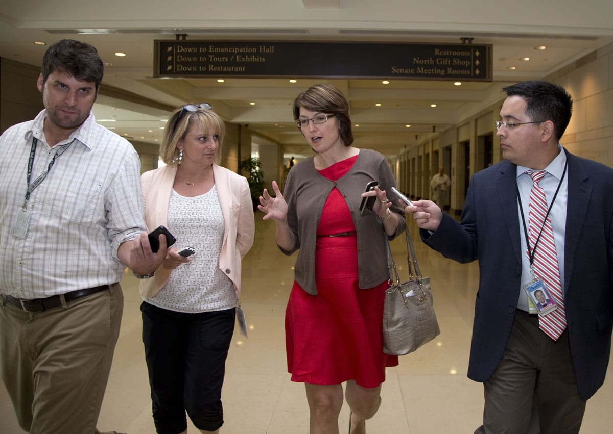 Rep. Cathy McMorris-Rodgers, R-Wash., third from left, walks with media from a closed members-only briefing on Syria on Capitol Hill on Sunday in Washington.