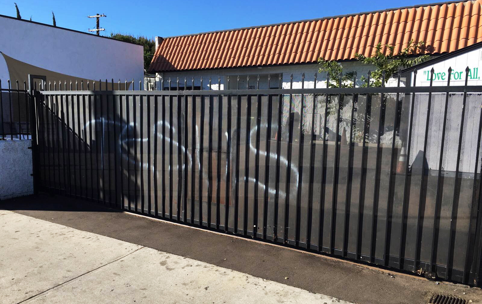 &quot;Jesus&quot; spelled out in spray paint is seen on a gate Sunday at the Ahmadiyya Muslim Community Baitus-Salaam Mosque in Hawthorne, Calif. The FBI is investigating after police there said two mosques were vandalized with paint and a fake grenade was left in the driveway of one of the properties.