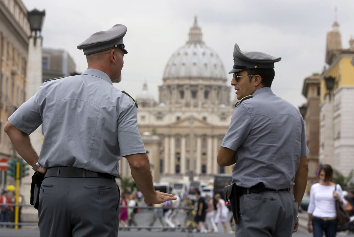 Italian financial police officers talk to each other in front of St.