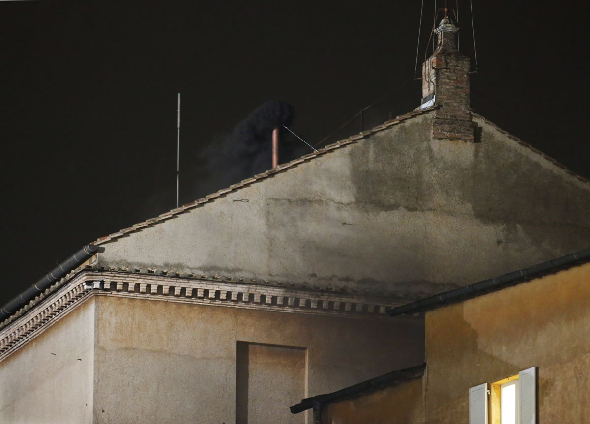 Smoke emerges from the chimney on the roof of the Sistine Chapel in St. Peter's Square at the Vatican on Tuesday.