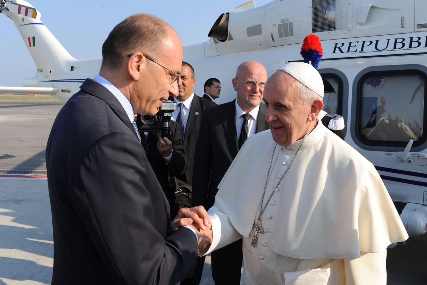 Pope Francis greets Italian Premier Enrico Letta at Rome's Leonardo Da Vinci international airport Monday.
