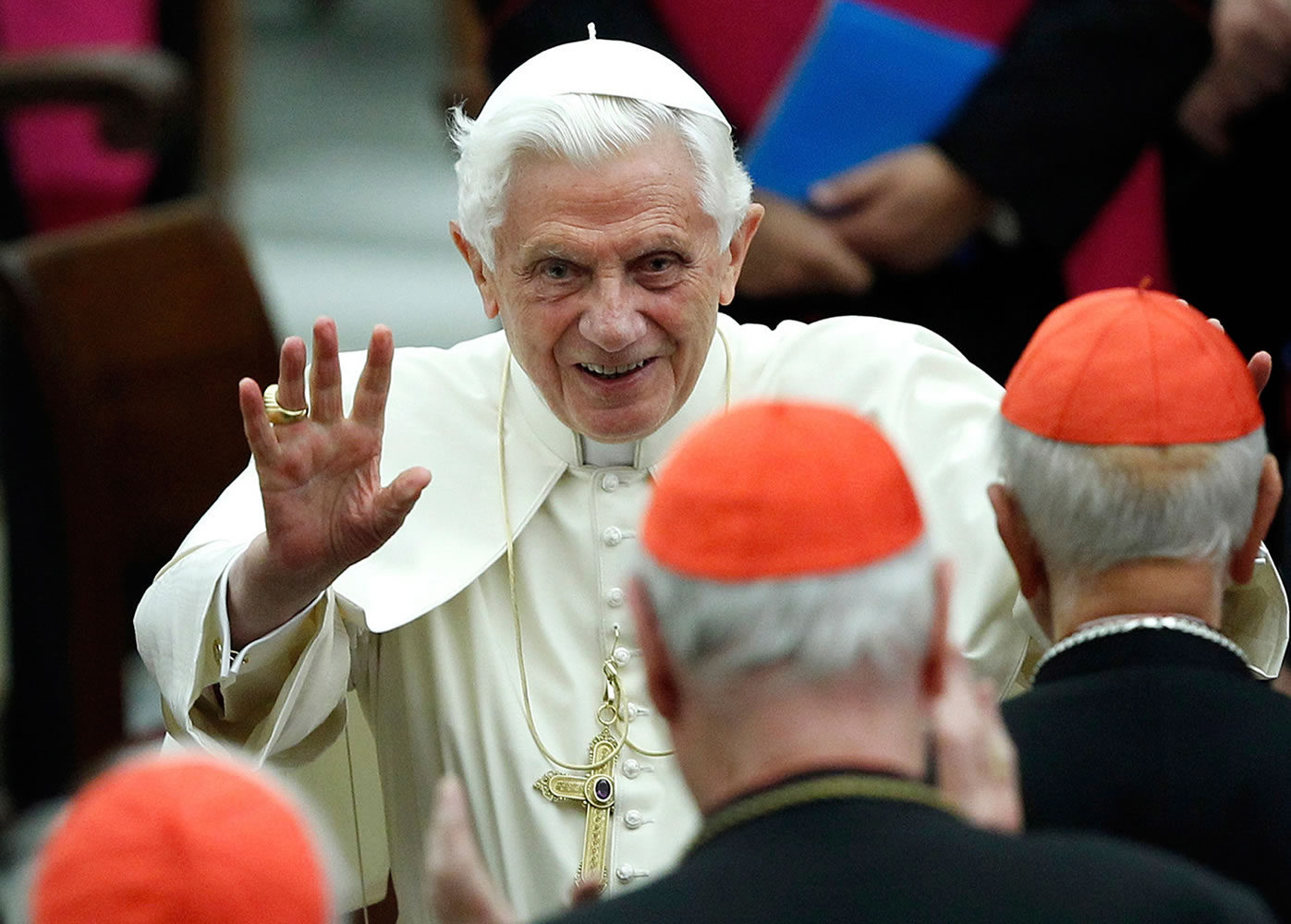 This Nov. 26, 2011 file photo shows Pope Benedict XVI waving as he leaves Paul VI hall after attending a concert of the Asturias Principality Symphony Orchestra directed by Chilean conductor Maximiano Valdes, at the Vatican. On Monday, Feb. 11, 2013 the Vatican announced that Pope Benedict XVI will resign on Feb.