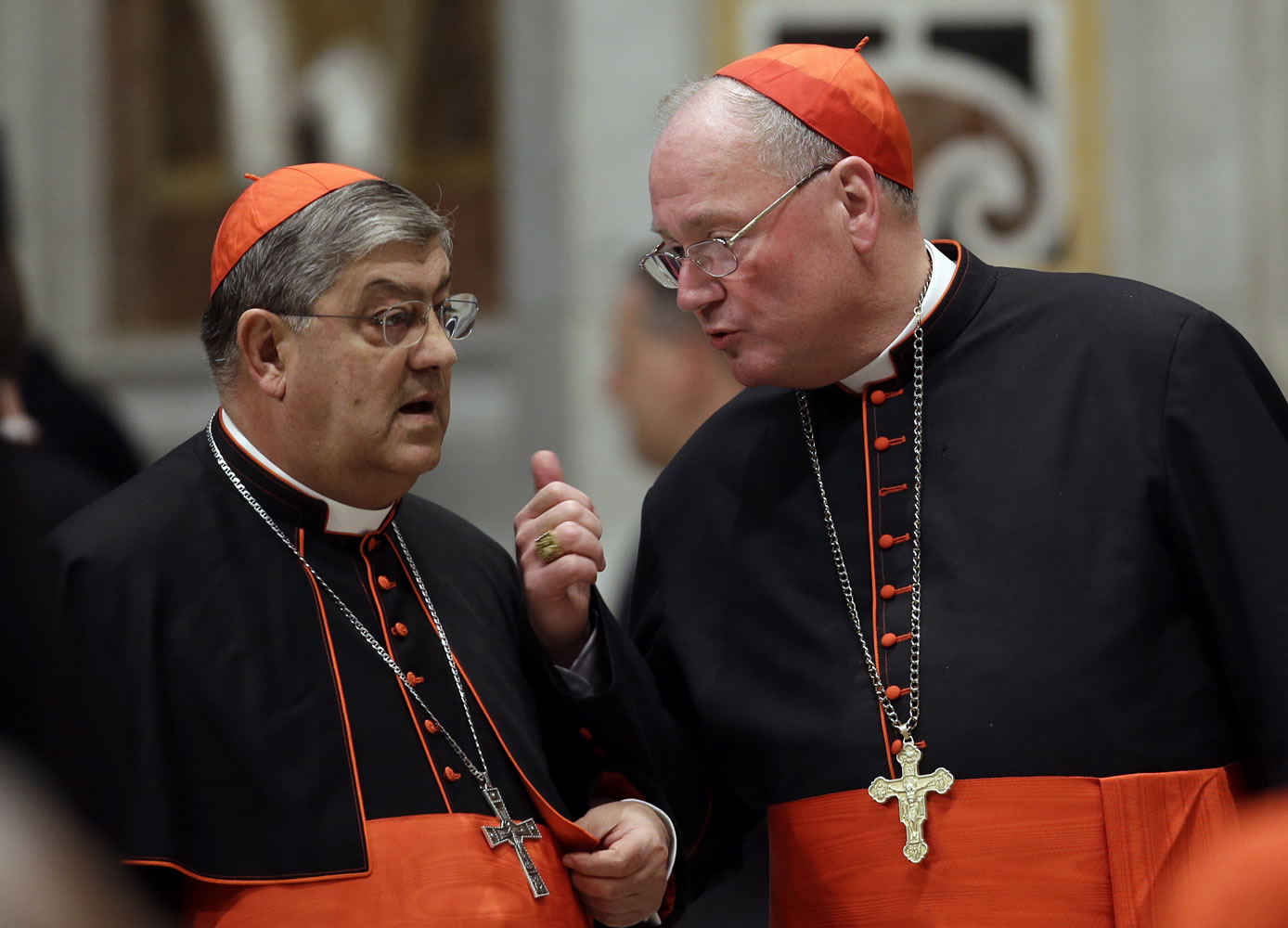 Cardinal Crescenzio Sepe, left, listens to Cardinal Timothy Dolan as they gather Wednesday in St.