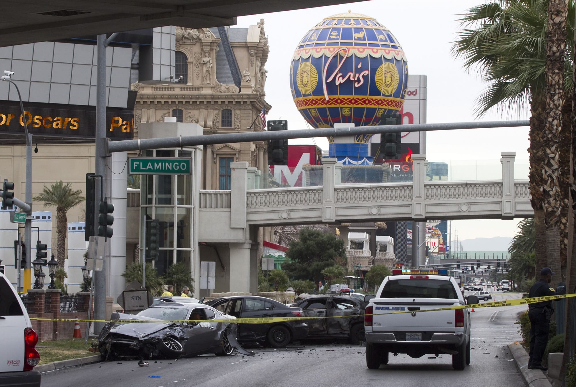 Police rope off the scene of a shooting and multi-car accident on the Las Vegas Strip early Thursday. Authorities say at least one person in a Range Rover shot at people in a Maserati that then crashed into a taxi cab. The taxi cab burst into flames, and the driver and passenger were killed.