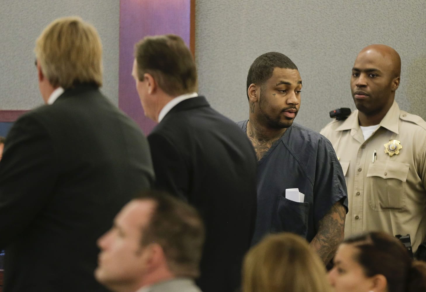 Ammar Harris stands next to public defenders Randall Pike, left, and David Schieck during his arraignment in district court Wednesday in Las Vegas. Harris is accused of firing fatal shots early Feb.
