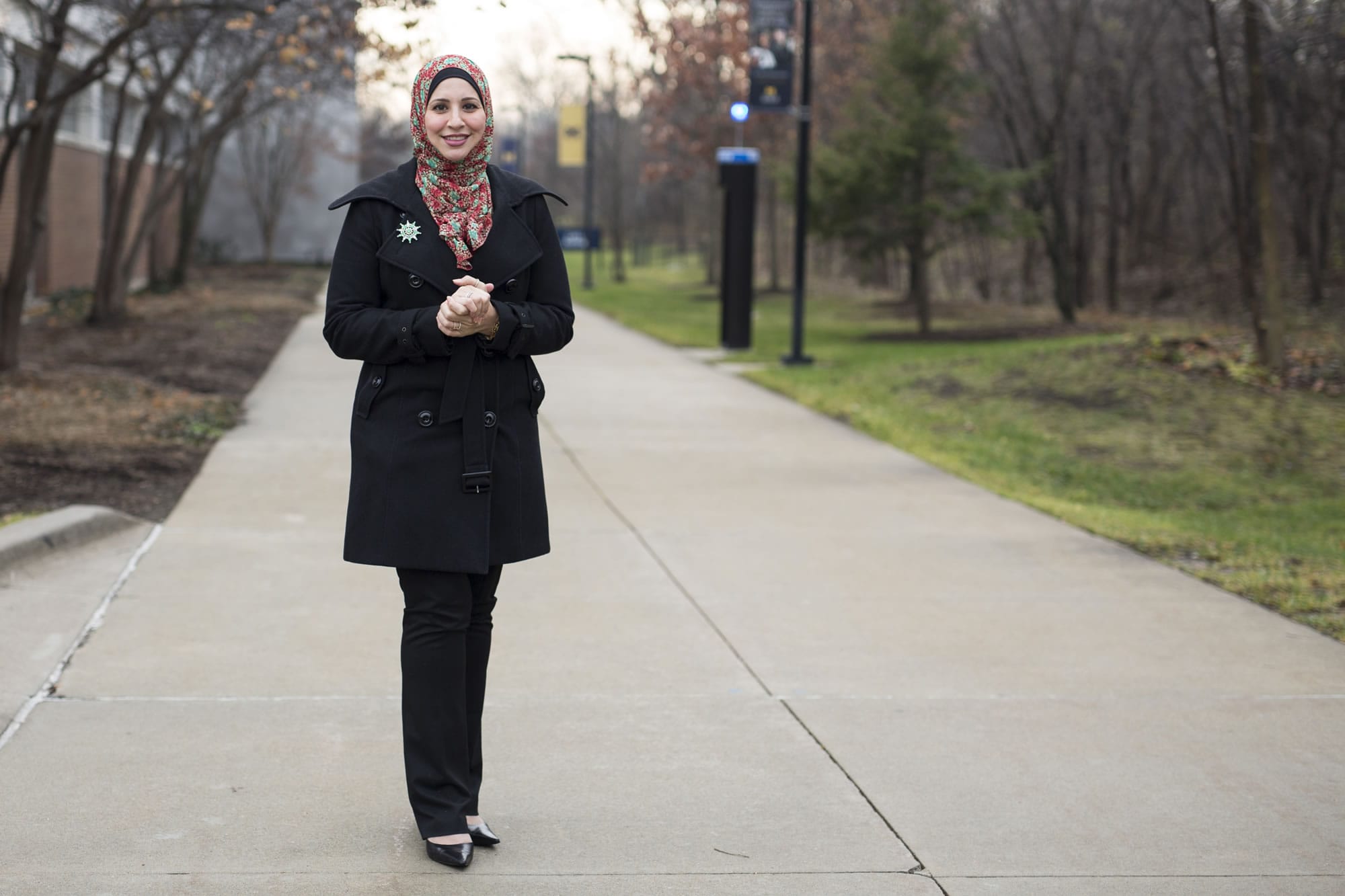 Suehaila Amen, coordinator of International Admissions and Recruitment at the University of Michigan Dearborn, is seen on campus Thursday in Dearborn, Mich. Amid the high level of harassment, threats and vandalism directed at American Muslims and at mosques, Muslim women are intensely debating the duty and risks related to wearing their head-coverings as usual.