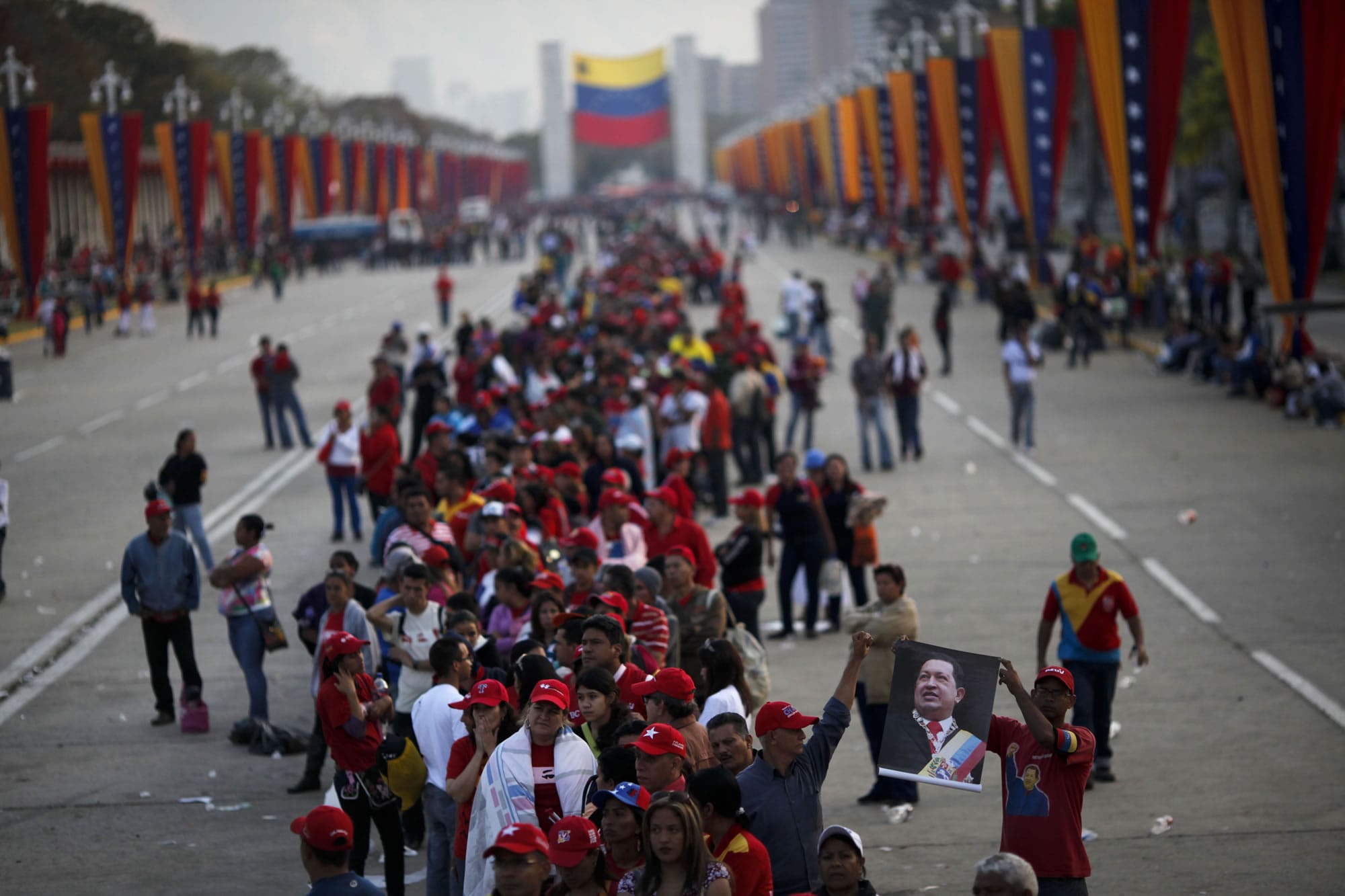 People line up Saturday to see the body of Venezuela's late President Hugo Chavez outside the military academy where he is lying in state in Caracas, Venezuela. Chavez died Tuesday after a nearly two-year bout with cancer.