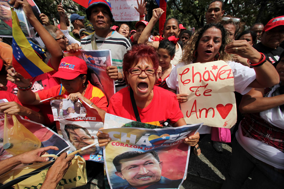 Supporters of Venezuela's President Hugo Chavez celebrate his return at Bolivar Square in Caracas, Venezuela, on Monday.