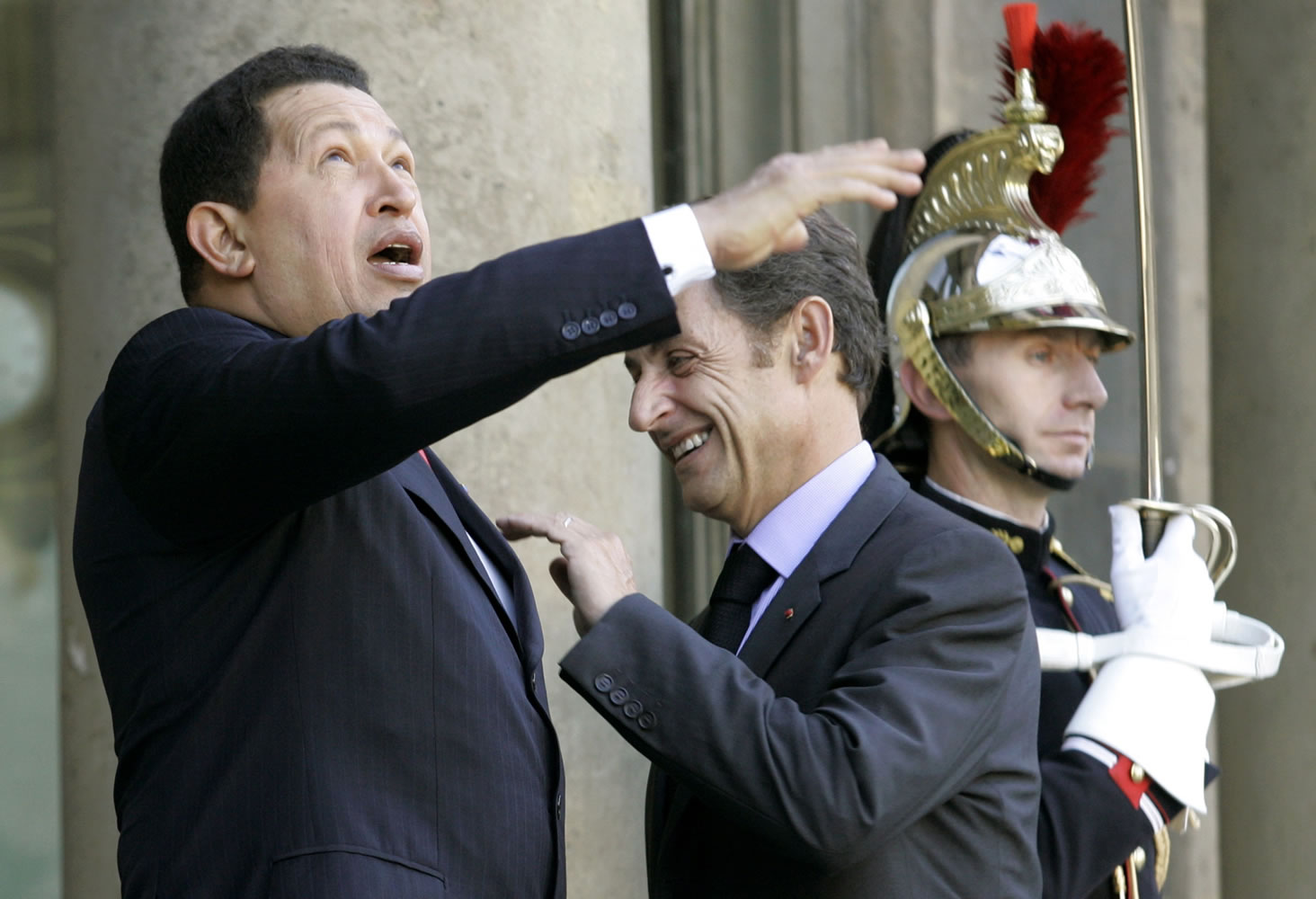 Then-French President Nicolas Sarkozy, center, and Venezuela's President Hugo Chavez share a light moment in Oct. 2008 prior to their meeting at the Elysee palace in Paris, France. Venezuela's Vice President Nicolas Maduro announced on Tuesday that Chavez has died.