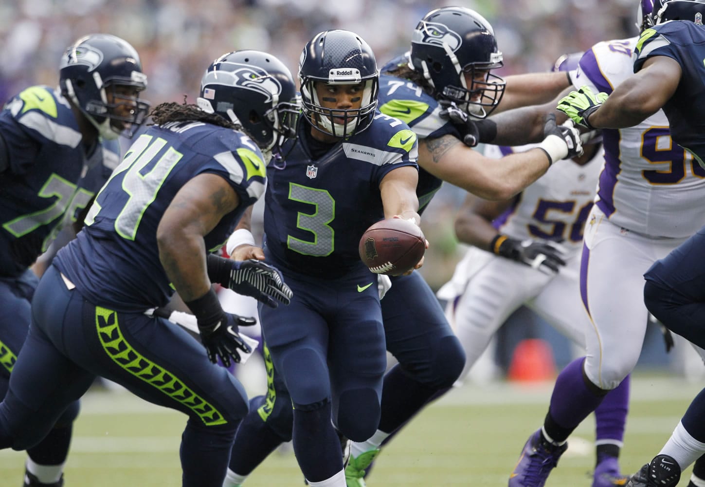 Seattle Seahawks quarterback Russell Wilson hands off to Marshawn Lynch (24) during the first half of an NFL football game against the Minnesota Vikings, Sunday, Nov. 4, 2012, in Seattle.