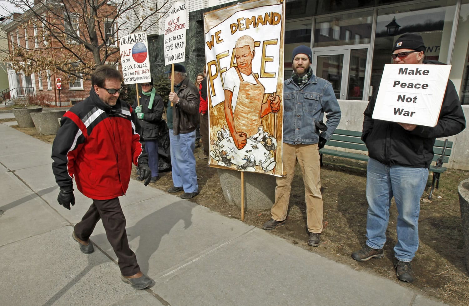 Protesters hold signs in front of the federal building in Montpelier, Vt., earlier this month.
