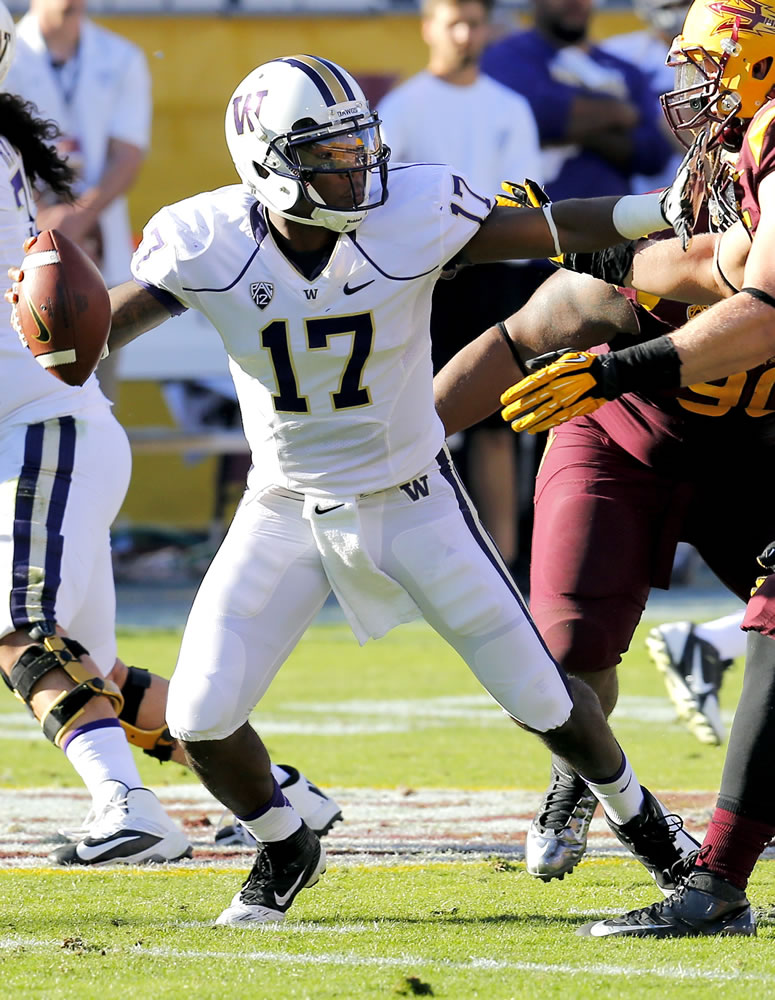 Washington quarterback Keith Price (17) looks to pass against Arizona State during the first half of an NCAA college football game, Saturday, Oct. 19, 2013, in Tempe, Ariz.