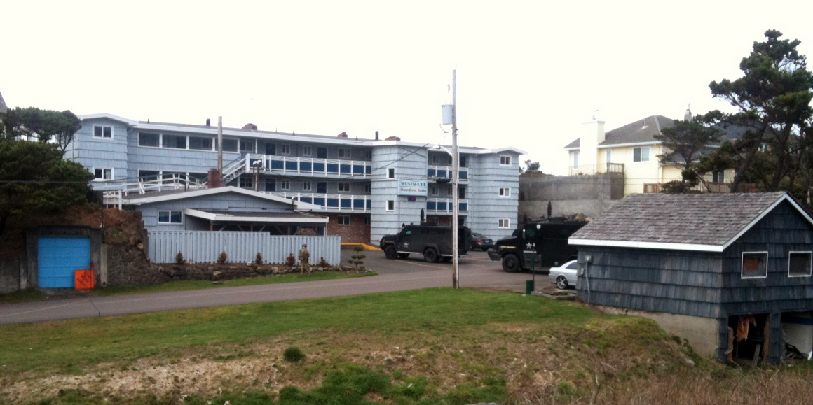 Police vehicles are parked outside of the Westshore Oceanfront Motel on Tuesday in Lincoln City, Ore.