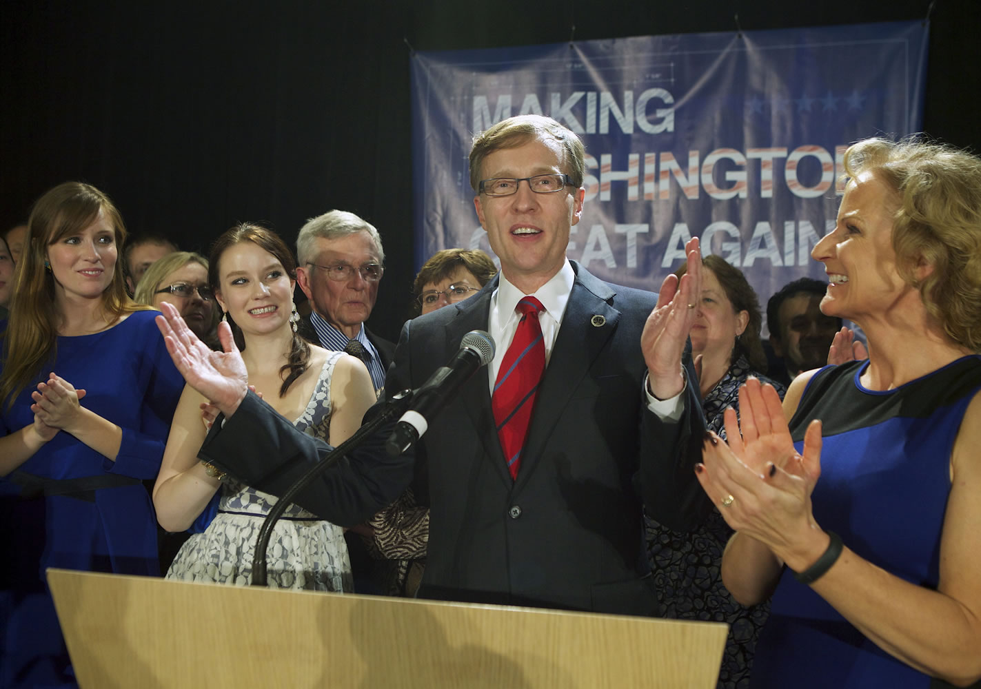 Rob McKenna, Republican candidate for Washington Governor, talks to supporters, while daughters Madelin, Katie and wife Marilyn applaud Tuesday in Bellevue