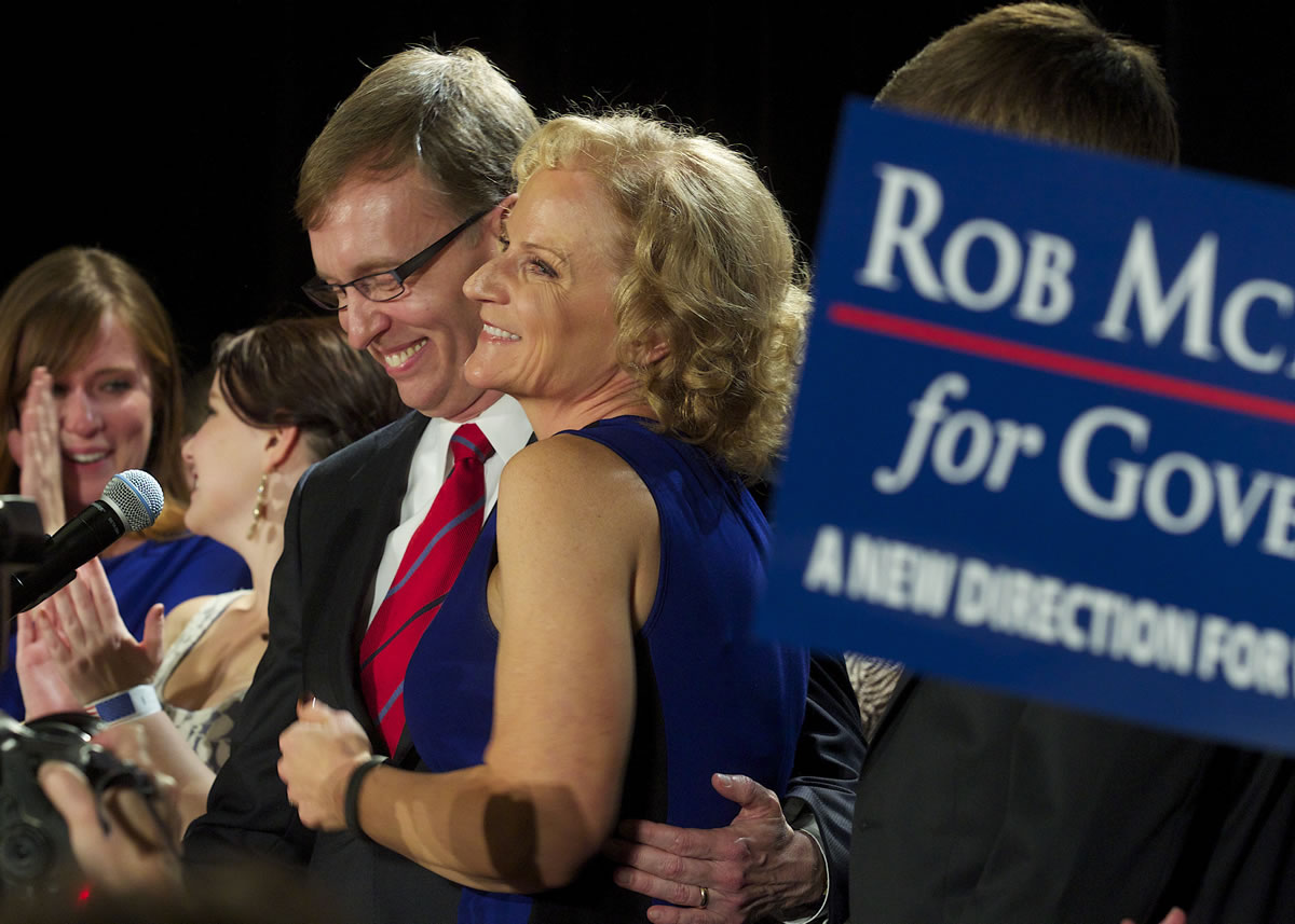 Republican candidate Rob McKenna embraces his wife, Marilyn, while talking to supporters Tuesday in Bellevue.