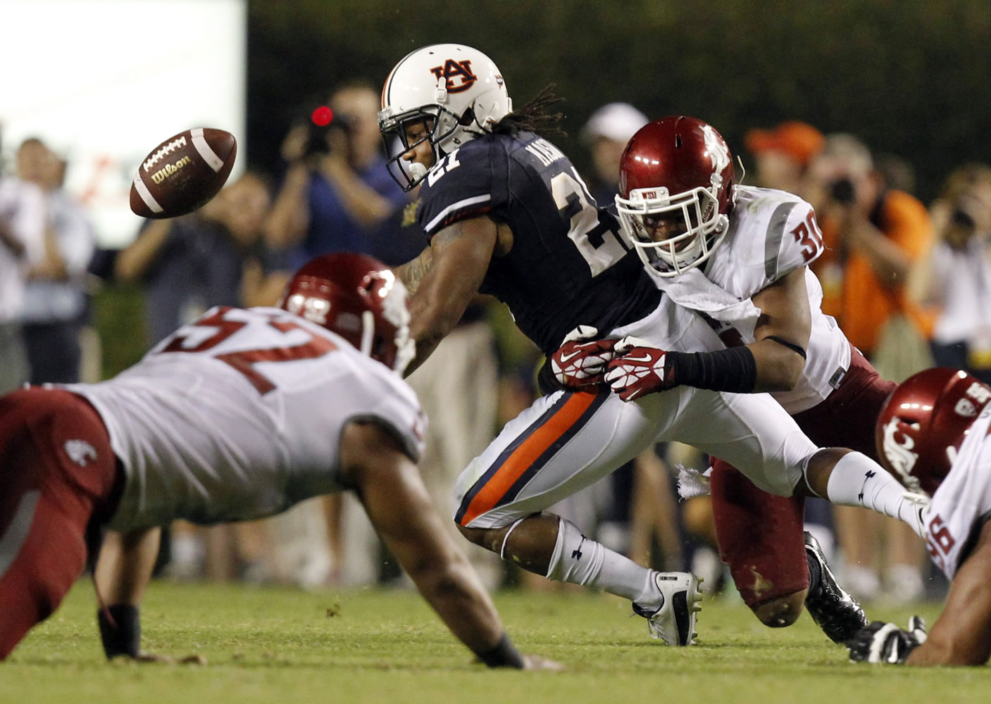 Washington State safety Taylor Taliulu (30) knocks the ball loose from Auburn running back Tre Mason during the second half  Saturday.