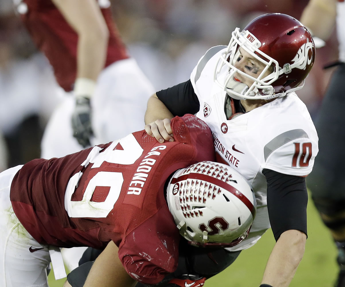 Washington State quarterback Jeff Tuel (10) is brought down by Stanford defensive end Ben Gardner during the second half Saturday.