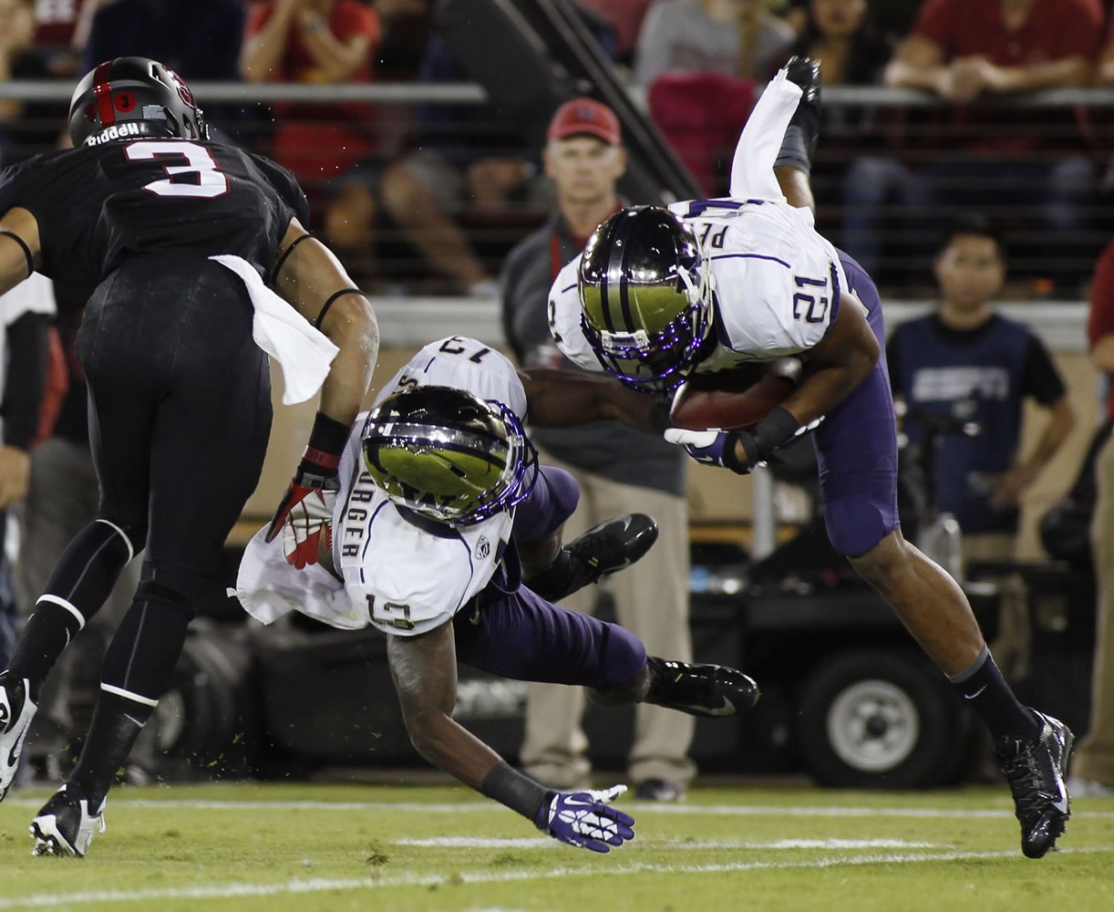 Washington's Marcus Peters, right, makes an interception against Stanford during the first half Saturday.