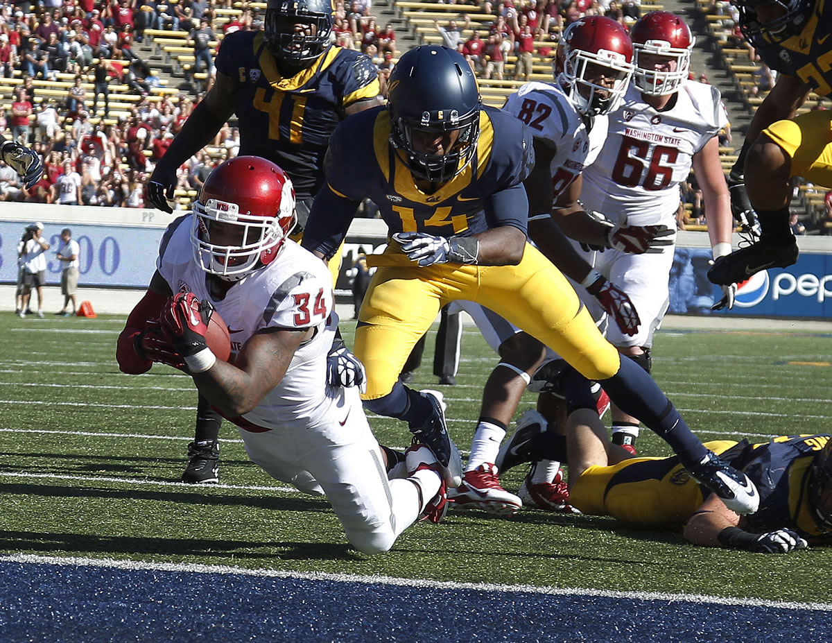 Washington State's Teondray Caldwell dives for a touchdown during the second half Saturday.