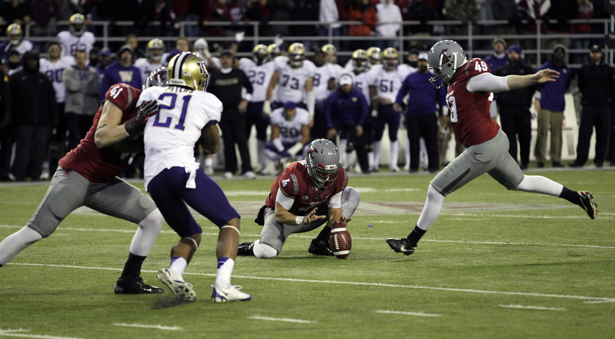 Washington State's Andrew Furney, right, kicks the game-winning field goal in overtime against Washington on Friday.