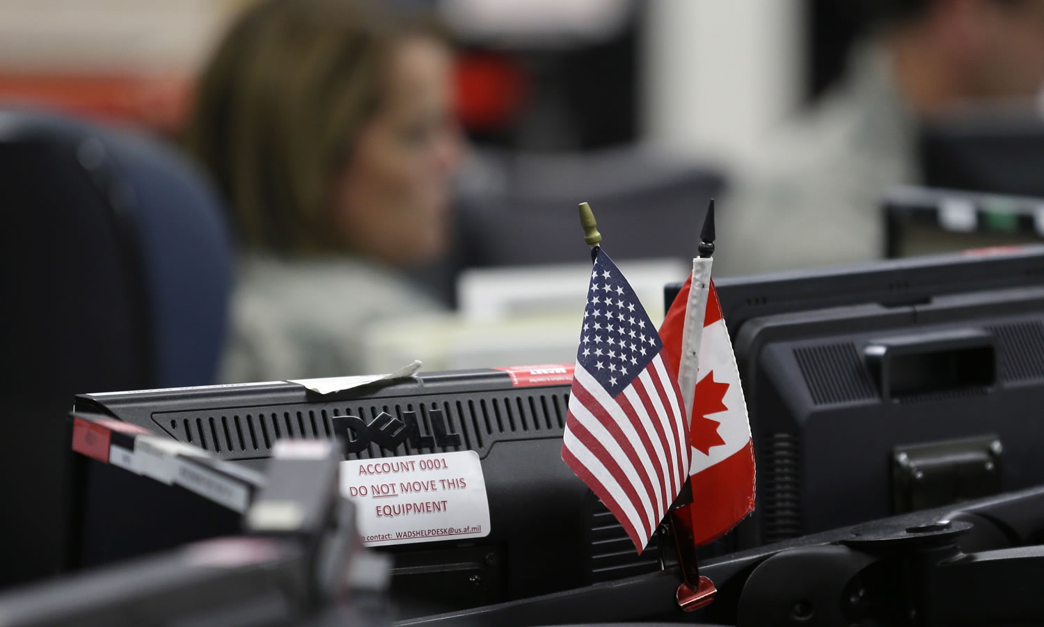 U.S. and Canadian flags are displayed near computer monitors at the Western Air Defense Sector at Joint Base Lewis-McChord in Washington state.
