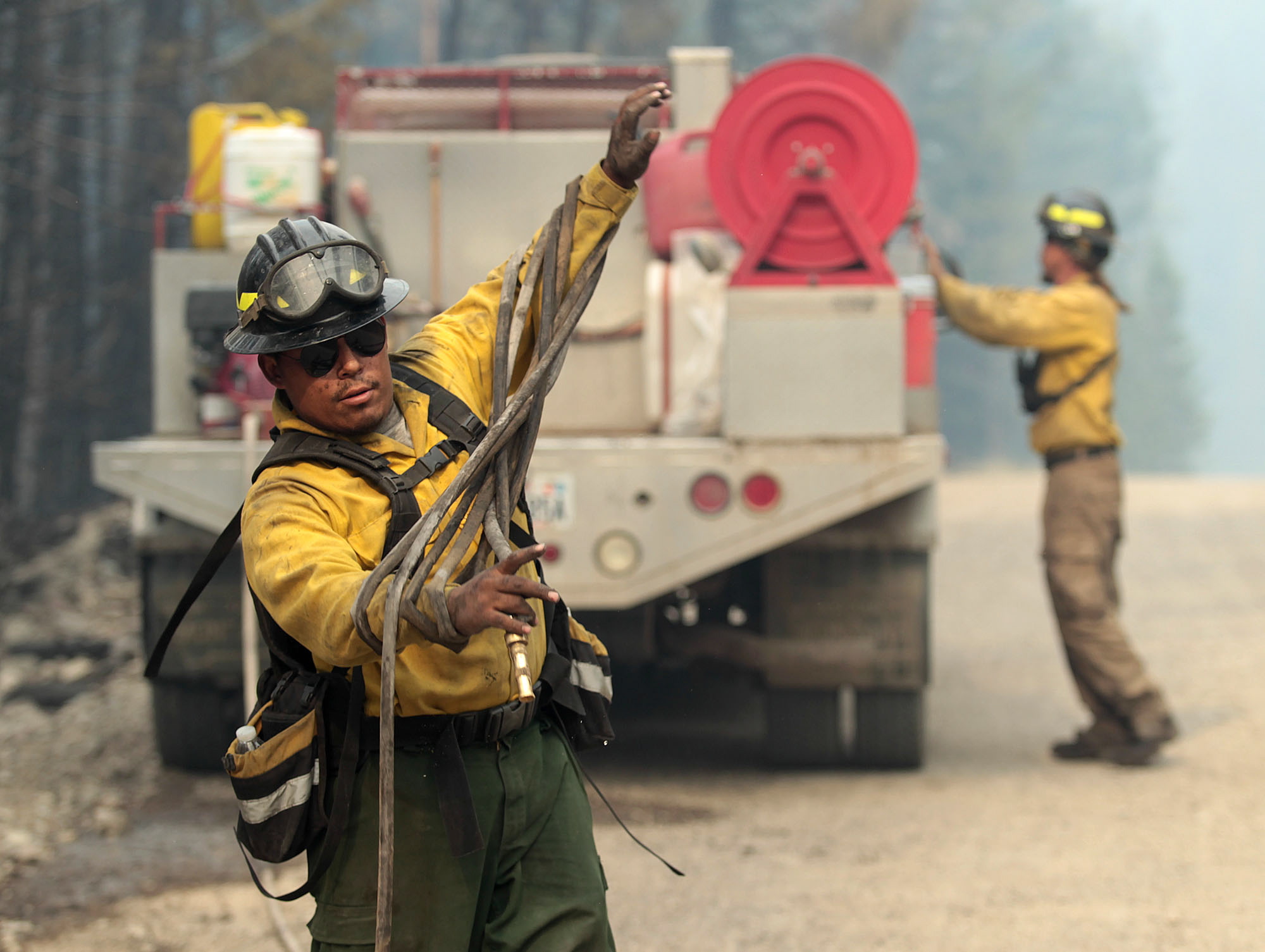 Firefighters with the private contract company Great Basin Fire mop up part of the 104,457-acre Beaver Creek Fire in the Baker Creek, north of Ketchum, Idaho.