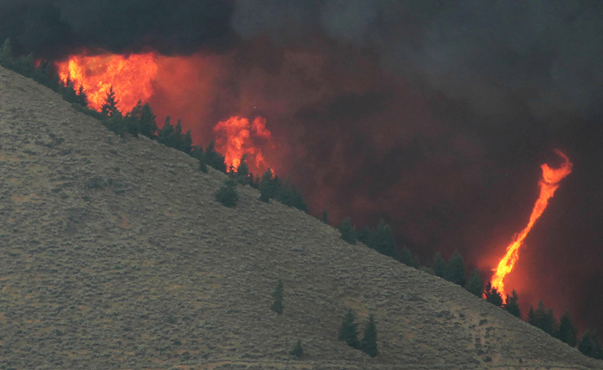 A fire whirl highlights the eratic wind conditions from the 64,000 acre Beaver Creek Fire on Friday, Aug., 16, 2013 north of Hailey, Idaho.