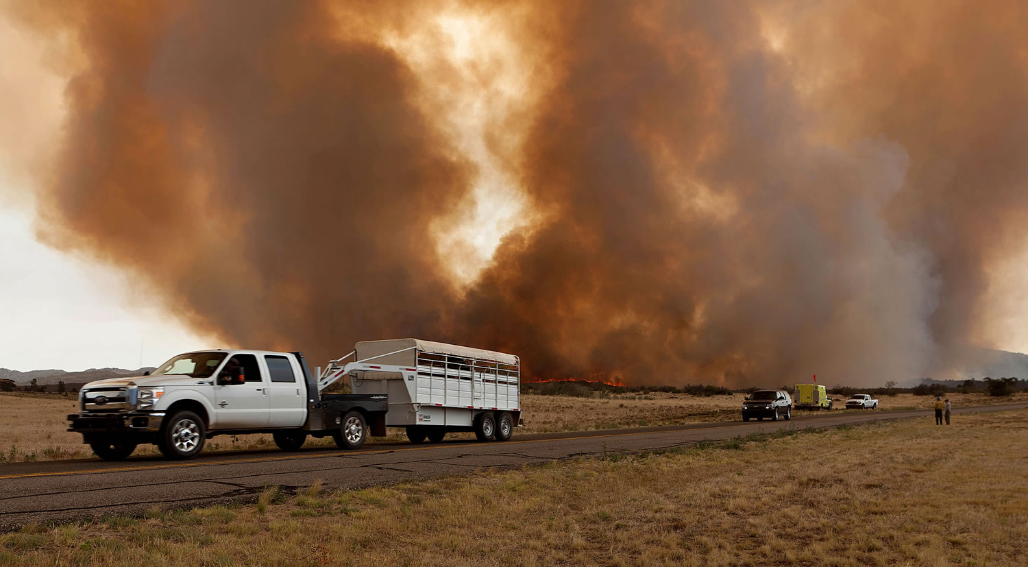 Residents evacuate along Hays Road in Peeples Valley, Ariz. as the Yarnell Hill fire advances  Sunday. The fire started Friday and picked up momentum under high temperatures, low humidity and wind.