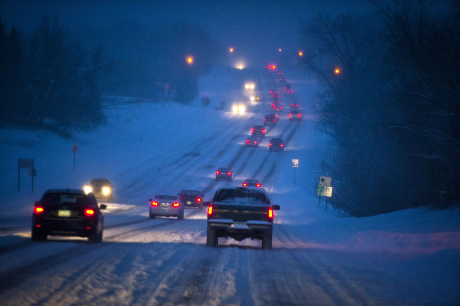 Heavy snow, especially toward the south suburbs made for slow traffic along Diffley Road in Eagan, Minn., on Friday.