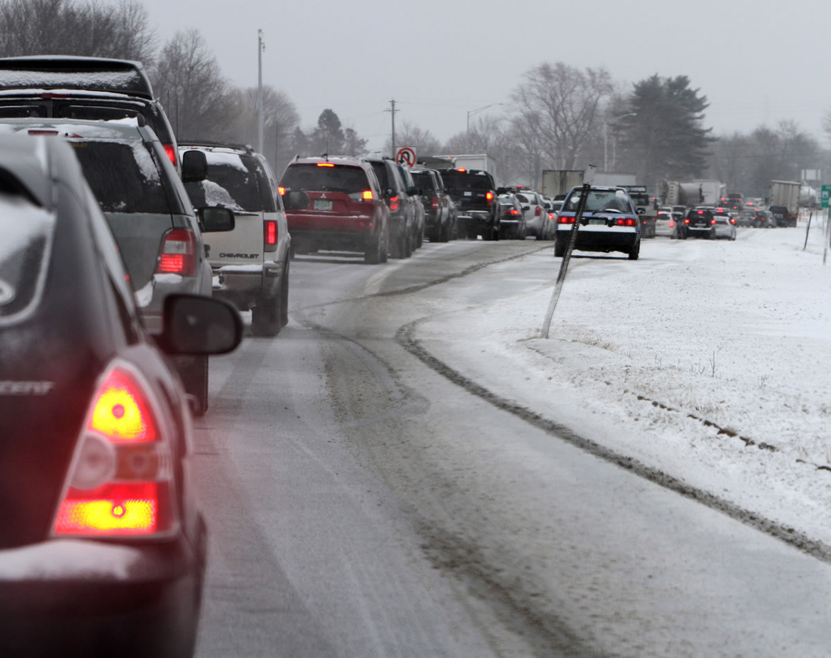 Cars are stuck in traffic as a winter storm arrives Fridayin Newington, N.H.