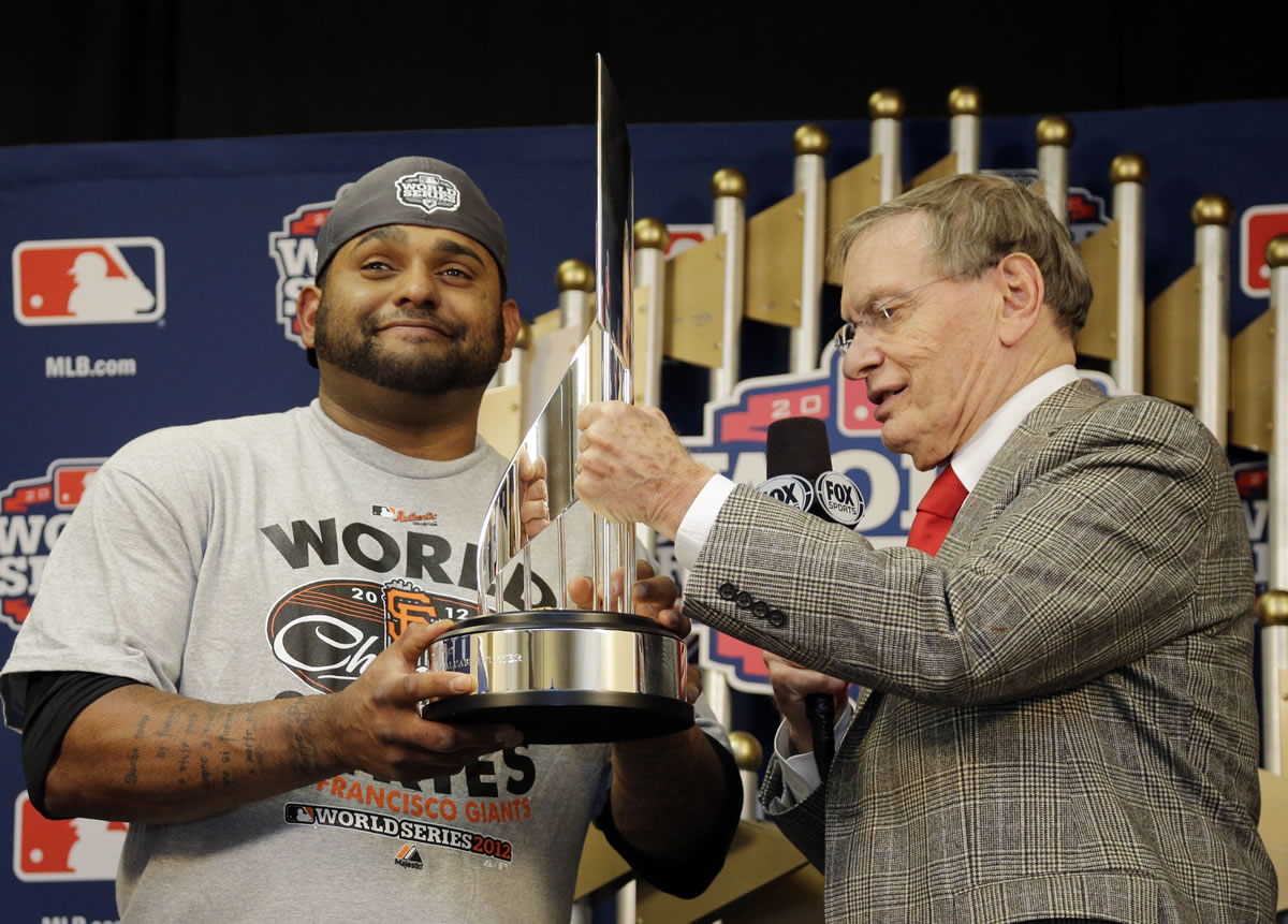Commissioner Bud Selig hands San Francisco Giants' Pablo Sandoval his MVP trophy after the Giants defeated the Detroit Tigers 4-3 in 10 innings to win the World Series on Sunday.
