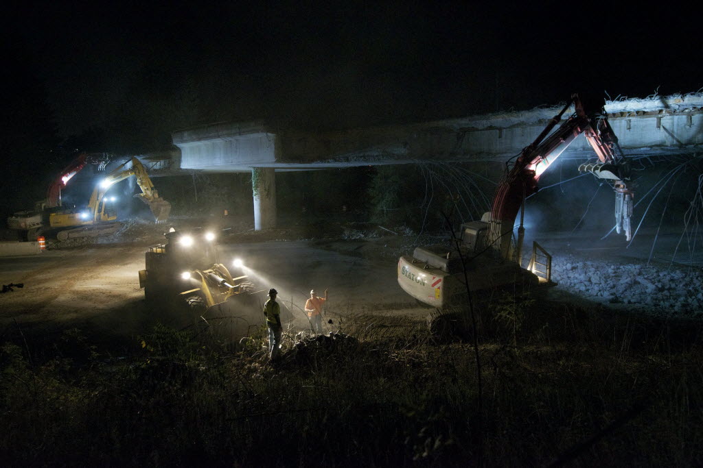 Construction crews use heavy machinery to rip out a freeway onramp that passes over Interstate 205 near Northeast 20th Avenue on Wednesday night in Salmon Creek.