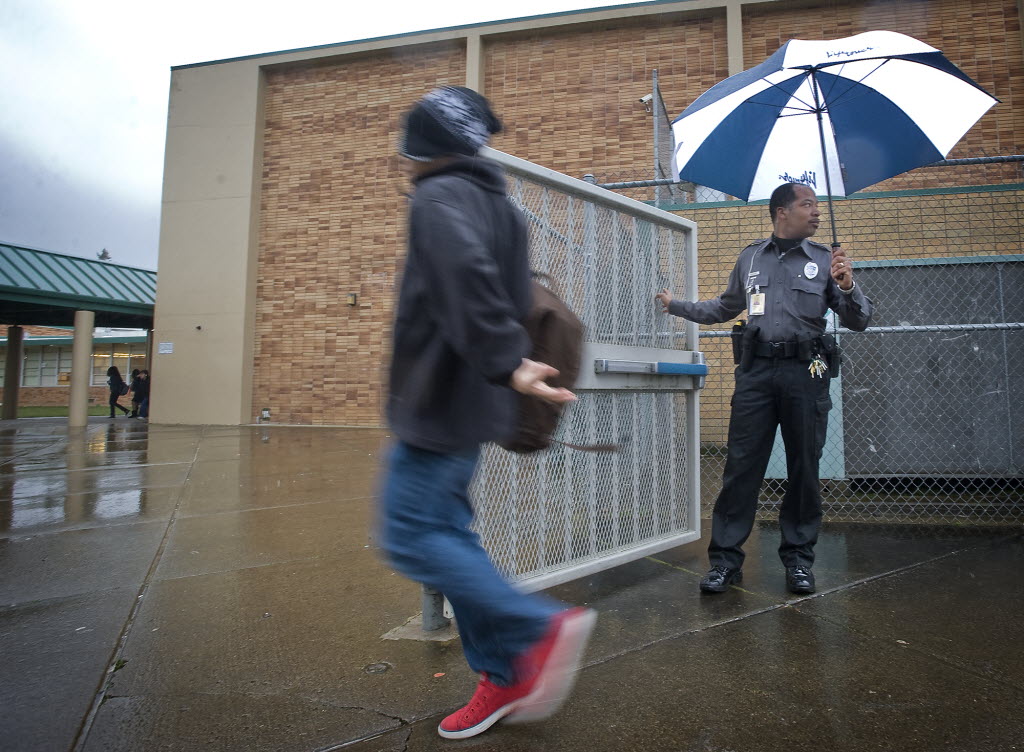 District Resource Officer Donald &quot;Raven&quot; Hubbard gets ready to lock an exterior gate as he makes sure children are headed to class at the start of the school day at McLoughlin Middle School on Feb. 14, 2012.