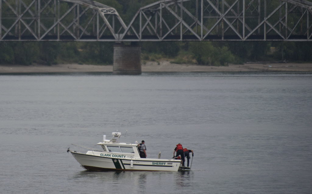 Clark County Sheriff's Office deputies recover a body from the Columbia River on Wednesday evening.