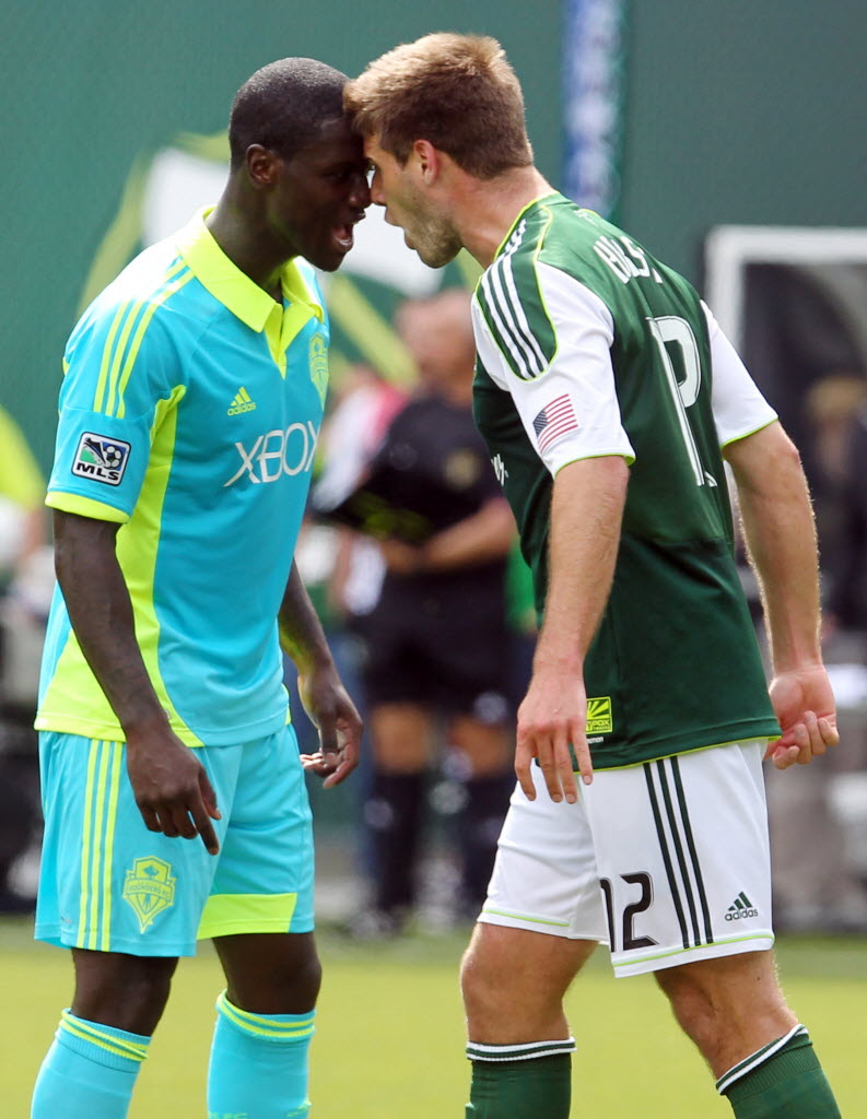 Seattle Sounders' Eddie Johnson, left, and Portland Timbers' David Horst (12) go head-to-head after a foul in the second half Sunday.