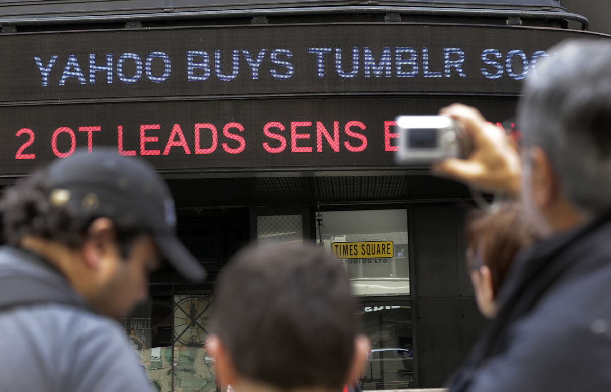 A news headline about the Tumblr sale to Yahoo scrolls on a building in New York's Times Square on Monday.