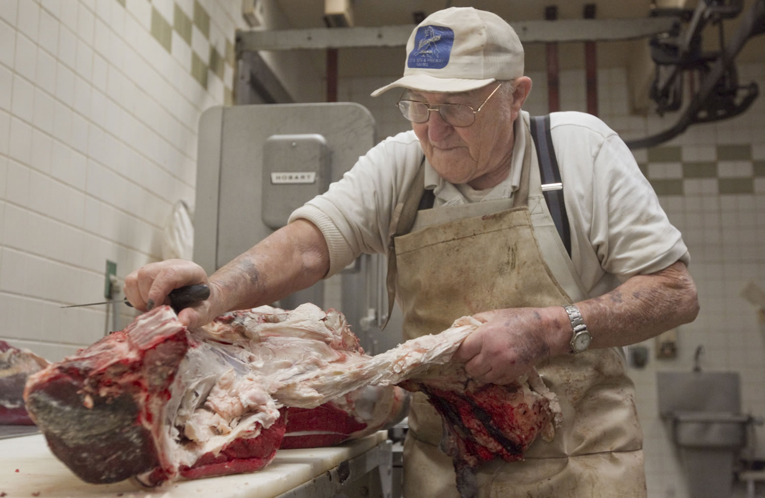 Fred Bucheli cuts up part of a cow in his Yakima butcher shop.