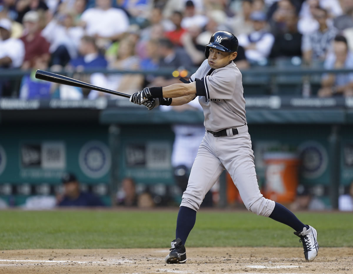 New York Yankees' Ichiro Suzuki swings on an RBI single in the third inning of a baseball game against the Seattle Mariners, Thursday, June 6, 2013, in Seattle. (AP Photo/Ted S.