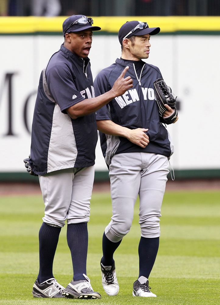 New York Yankees' Curtis Granderson, left, chats with Ichiro Suzuki before Monday's game against the Seattle Mariners.
