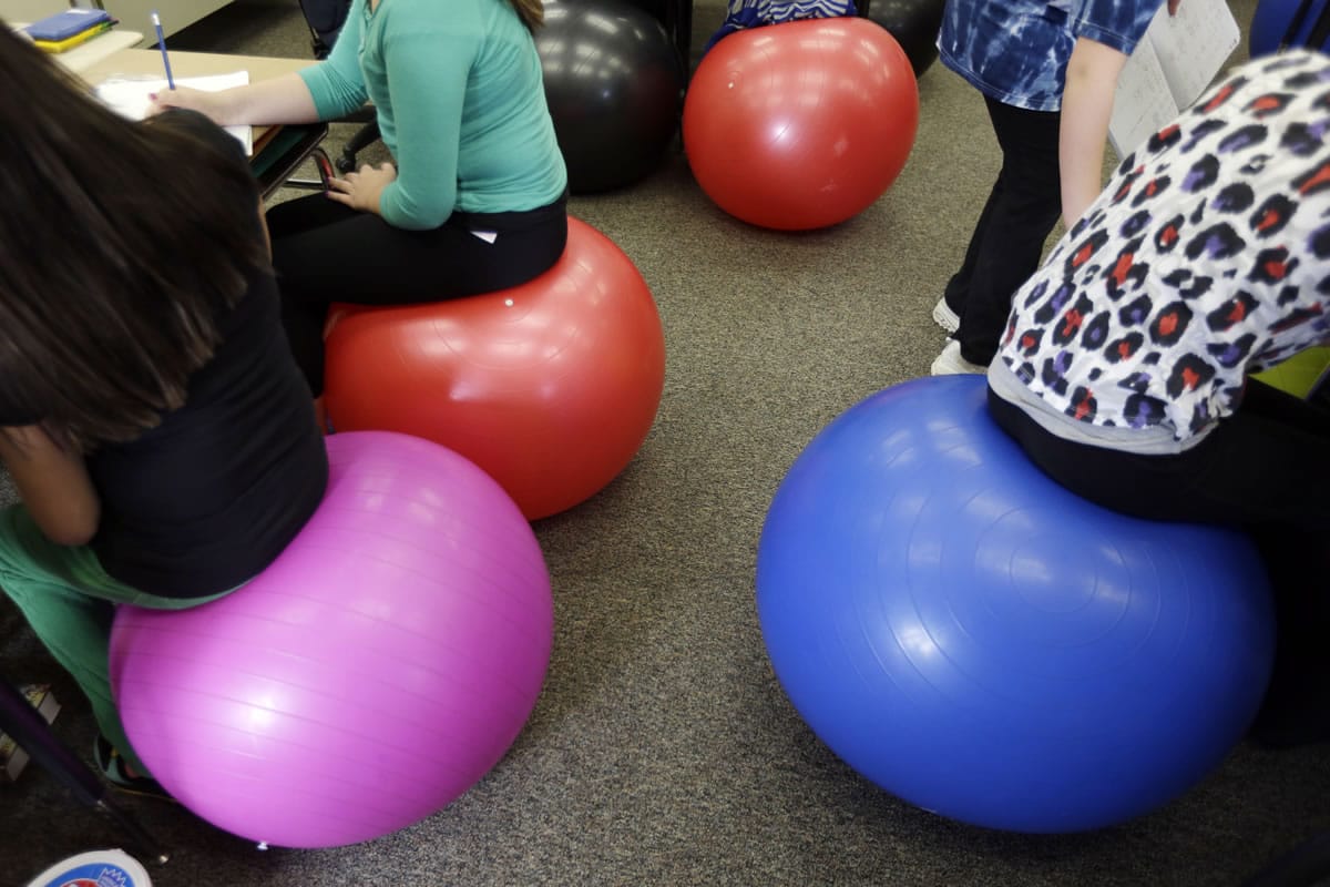 Students in Robbi Giuliano's fifth-grade class sit on yoga balls as they complete their assignments at Westtown-Thornbury Elementary School in West Chester, Pa.
